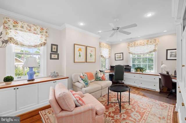 living room with ceiling fan, crown molding, and light hardwood / wood-style floors