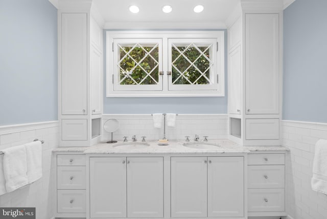 bathroom with ornamental molding and vanity