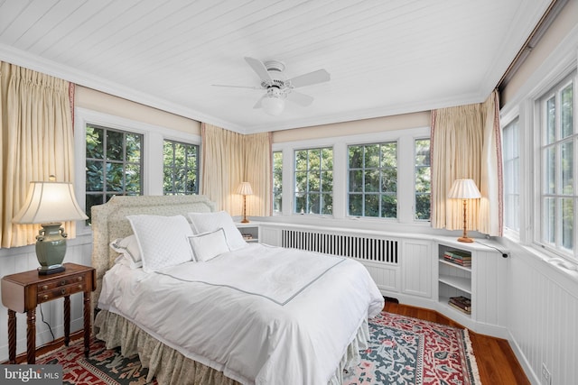 bedroom with ceiling fan, multiple windows, and wood-type flooring