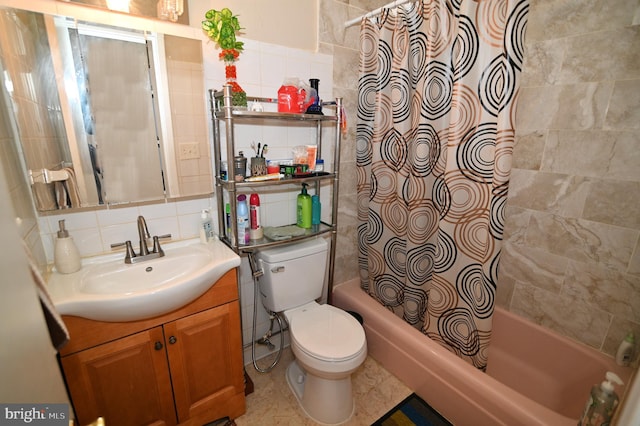 full bath with backsplash, tile walls, shower / bath combo, and vanity