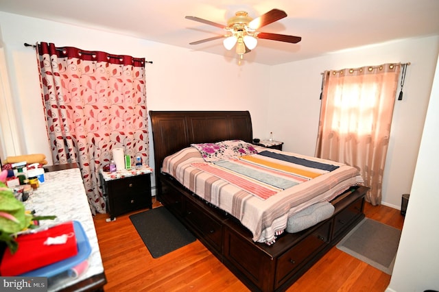 bedroom with light wood-type flooring and ceiling fan