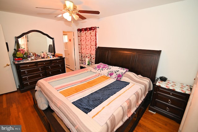 bedroom with ceiling fan and dark wood finished floors