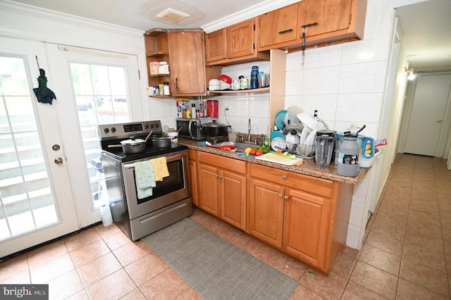 kitchen featuring light tile patterned floors, open shelves, a sink, appliances with stainless steel finishes, and backsplash