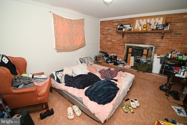 bedroom with tile patterned floors, ornamental molding, and brick wall