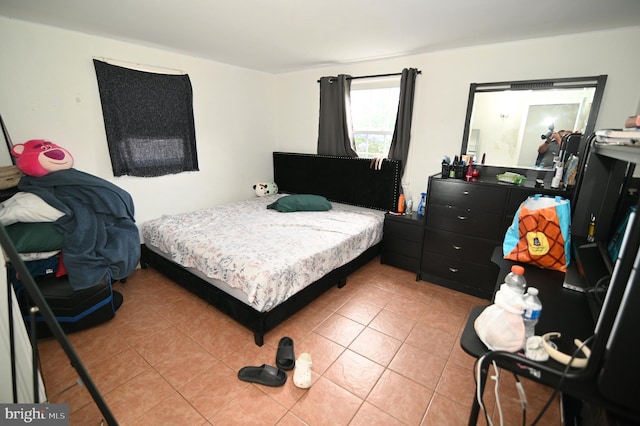 bedroom with light tile patterned floors