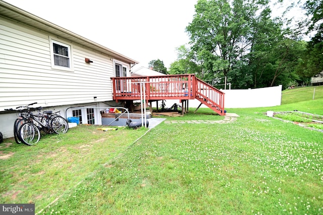 view of yard with stairway, a deck, and fence