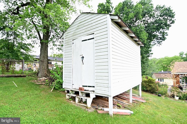 view of shed featuring fence