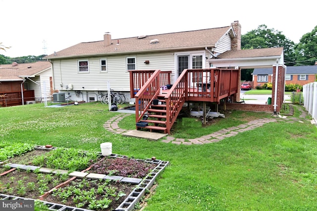 rear view of house with fence, a garden, central AC, a chimney, and a lawn