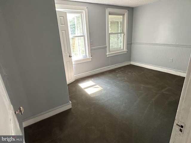 spare room with a textured ceiling