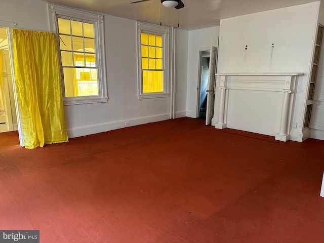 unfurnished living room with ceiling fan