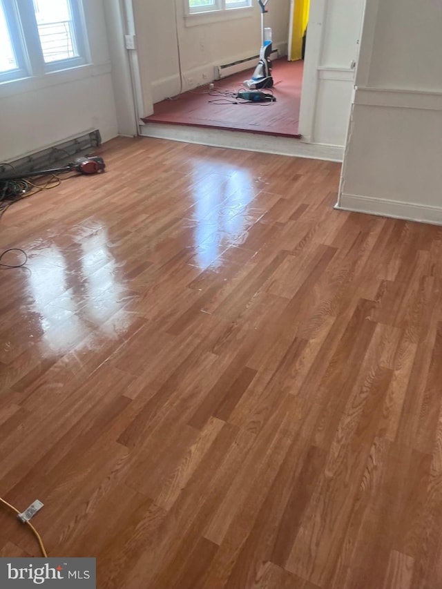 foyer with a baseboard heating unit and hardwood / wood-style floors