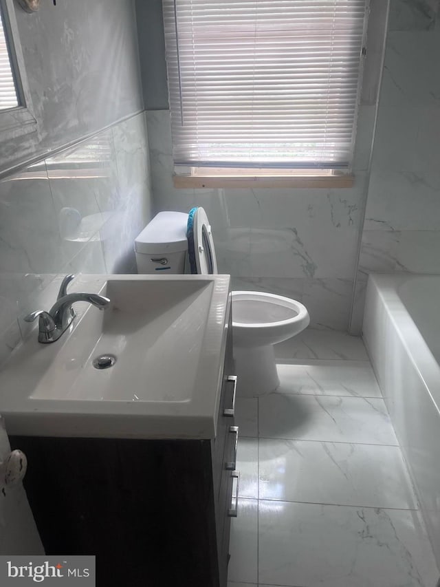 bathroom featuring tile walls, tile patterned floors, toilet, and vanity