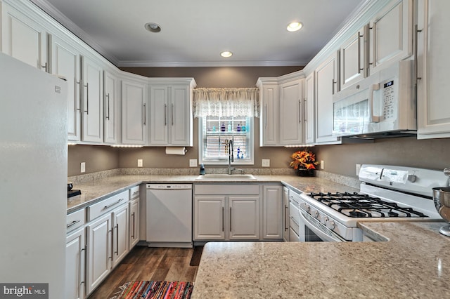 kitchen with white cabinetry, sink, dark hardwood / wood-style flooring, crown molding, and white appliances