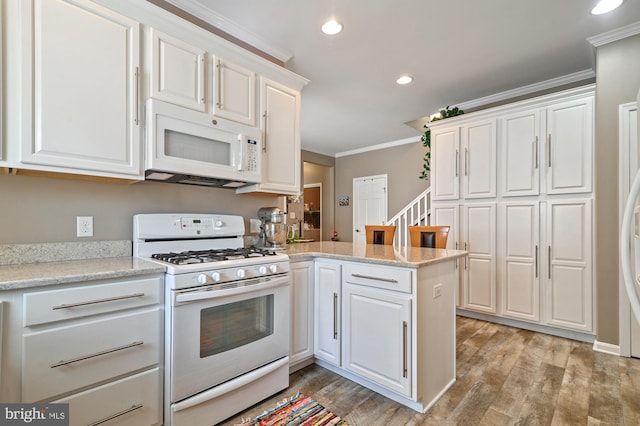 kitchen featuring crown molding, white cabinets, white appliances, and kitchen peninsula