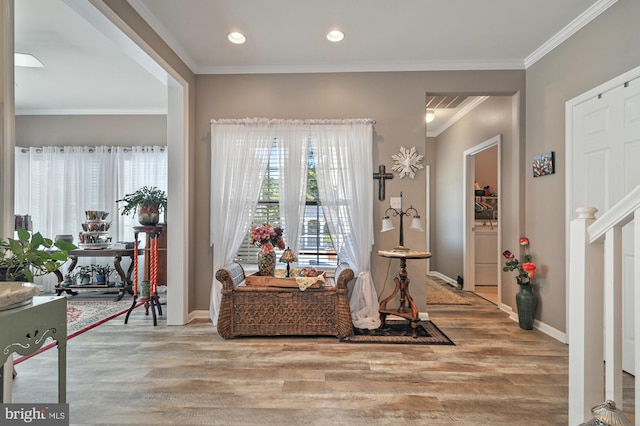 living area featuring ornamental molding and light wood-type flooring