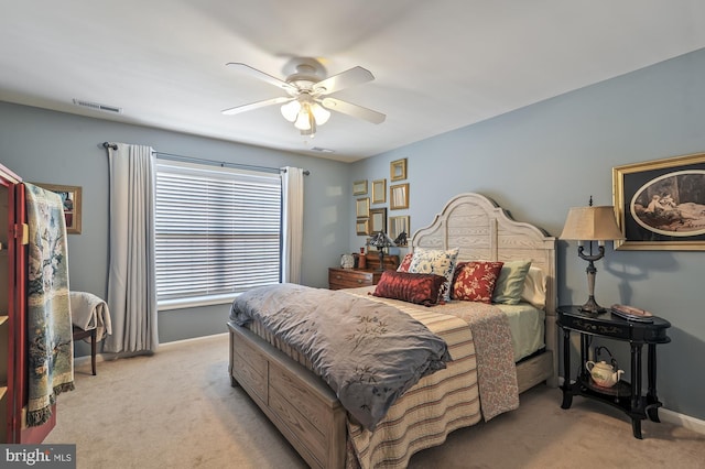 bedroom featuring ceiling fan and light carpet