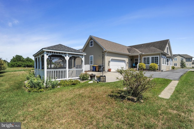 single story home featuring a front lawn and a garage