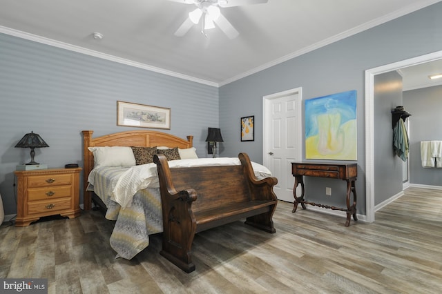 bedroom featuring hardwood / wood-style floors, ornamental molding, and ceiling fan