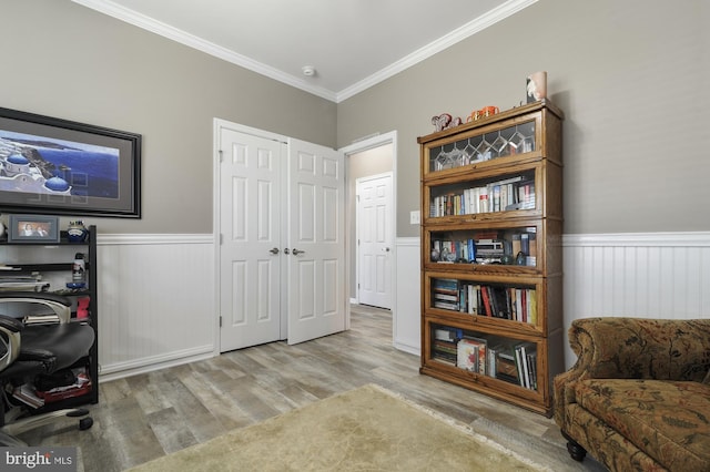 sitting room featuring crown molding and light wood-type flooring