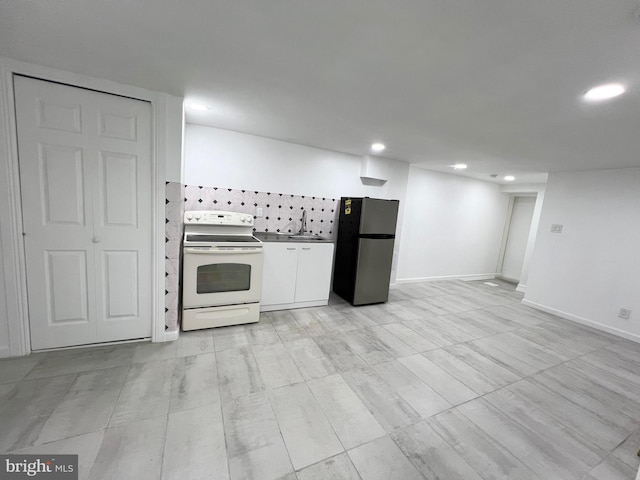 kitchen featuring sink, white electric range oven, and stainless steel refrigerator