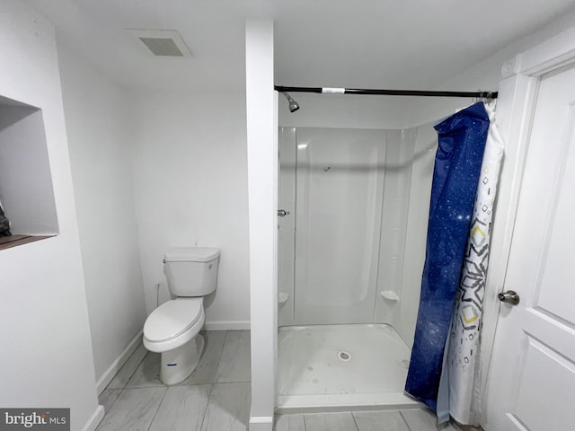 bathroom featuring toilet and a shower with shower curtain