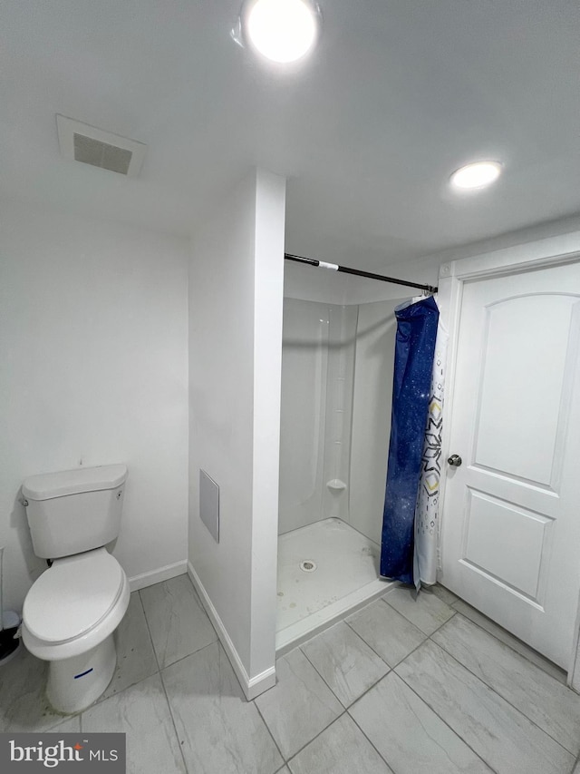 bathroom with toilet and walk in shower