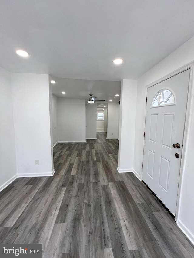 foyer with ceiling fan and dark wood-type flooring