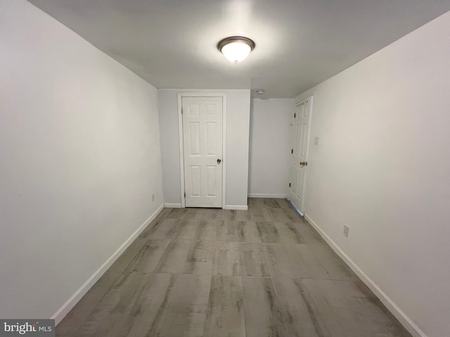 corridor with light hardwood / wood-style flooring