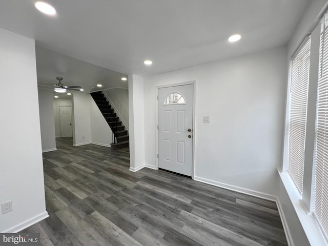 entrance foyer with ceiling fan and dark wood-type flooring