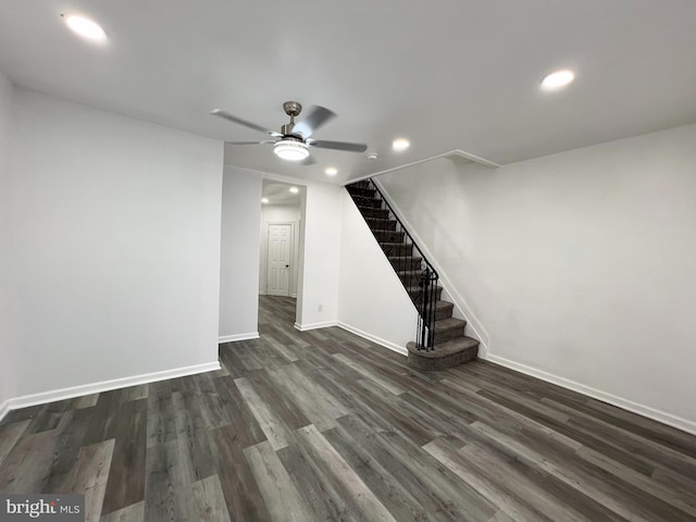 unfurnished living room featuring ceiling fan and dark hardwood / wood-style flooring