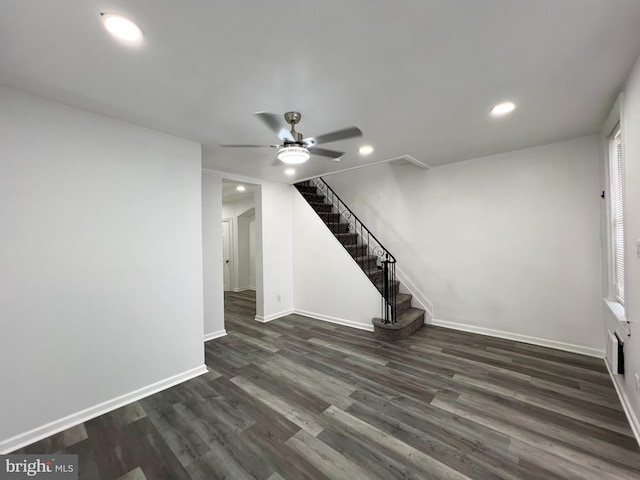 interior space with ceiling fan and dark hardwood / wood-style flooring