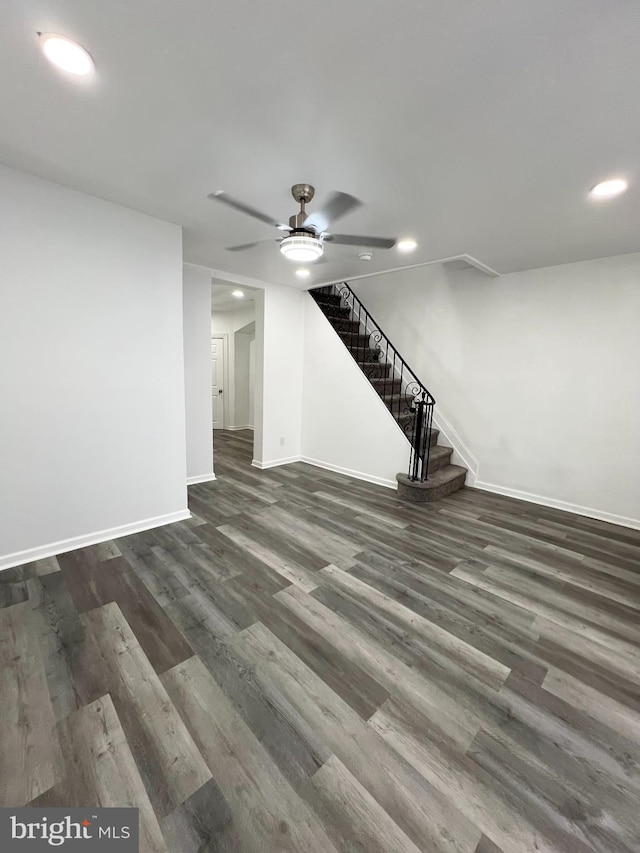 basement featuring ceiling fan and dark hardwood / wood-style flooring