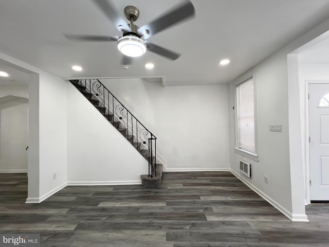 foyer entrance with ceiling fan and dark wood-type flooring