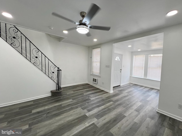 entrance foyer featuring ceiling fan, dark wood-type flooring, and a healthy amount of sunlight