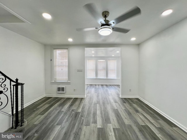 unfurnished living room featuring ceiling fan and dark hardwood / wood-style floors