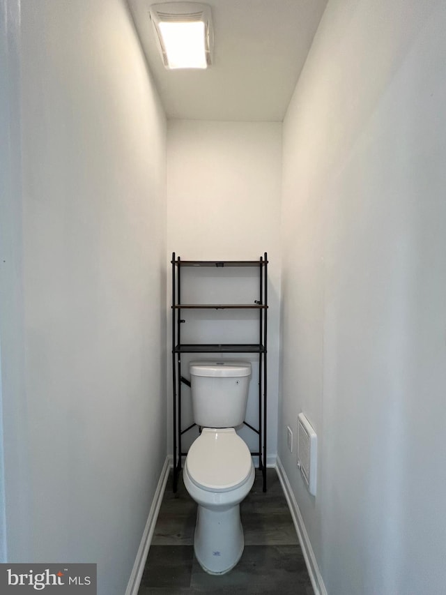 bathroom with toilet and hardwood / wood-style flooring