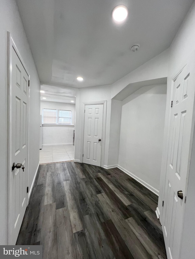 hallway with dark hardwood / wood-style floors