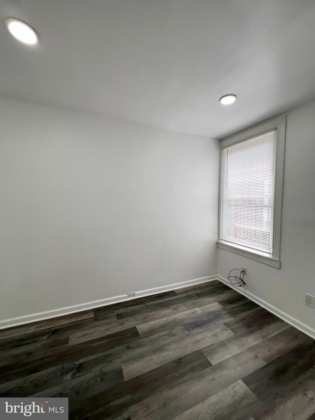 unfurnished room featuring dark hardwood / wood-style flooring