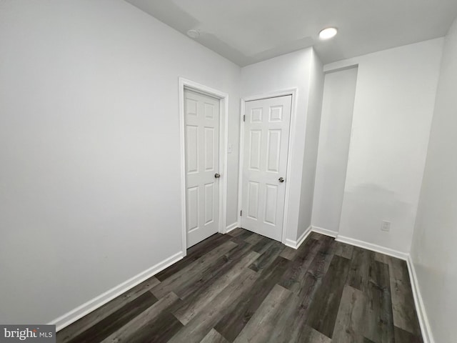 unfurnished room with dark hardwood / wood-style flooring