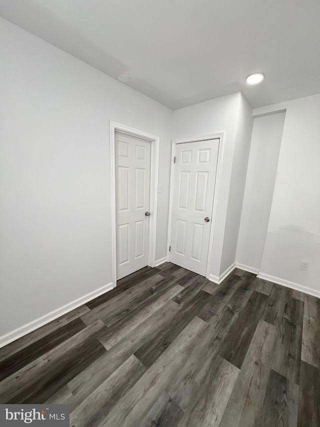 spare room featuring dark hardwood / wood-style flooring