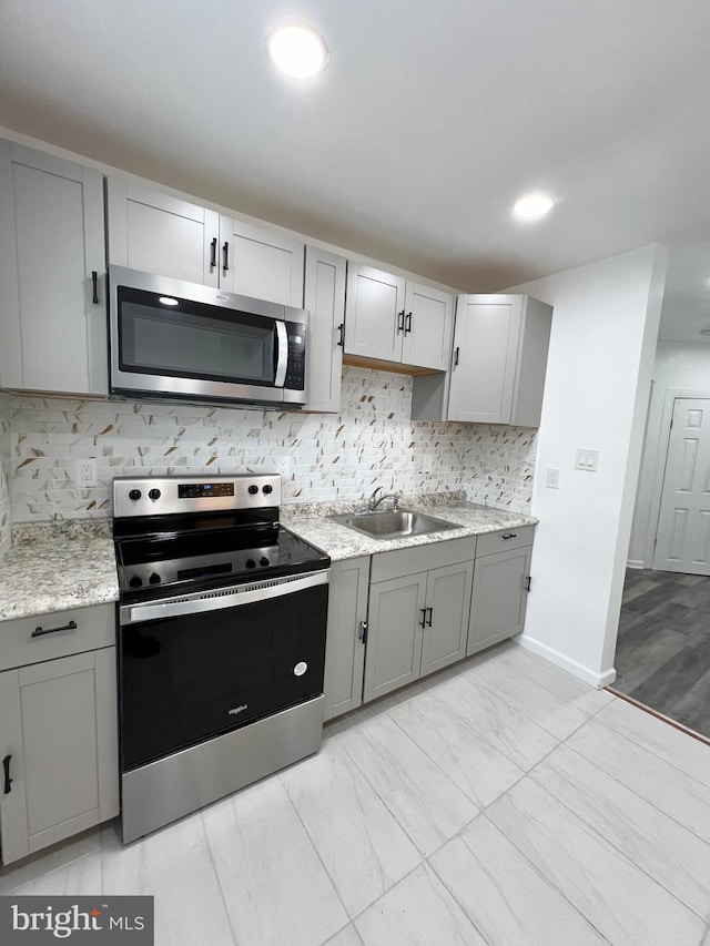 kitchen with sink, gray cabinetry, and stainless steel appliances