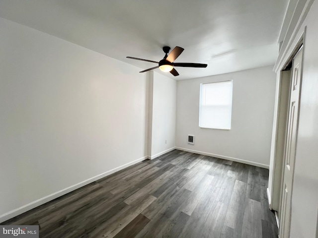 unfurnished bedroom featuring ceiling fan, a closet, and dark hardwood / wood-style floors