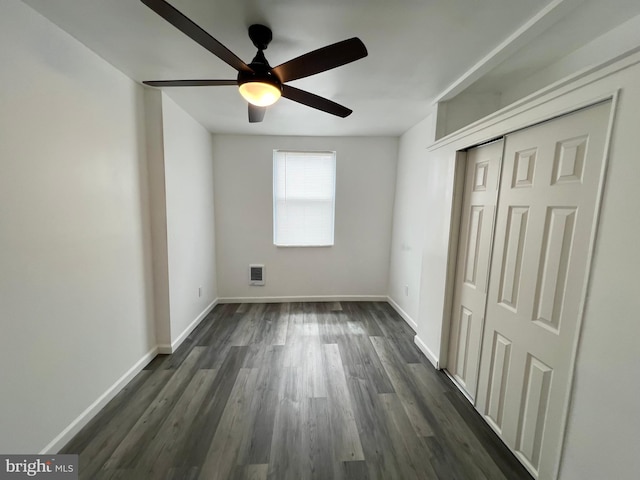 unfurnished bedroom featuring ceiling fan, a closet, and dark hardwood / wood-style floors