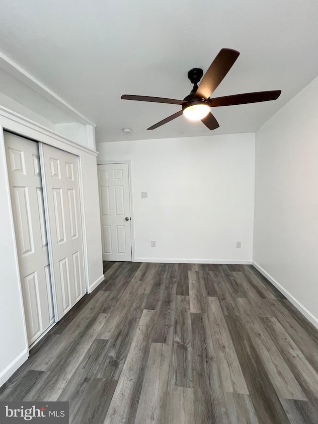 unfurnished bedroom featuring ceiling fan and dark hardwood / wood-style floors