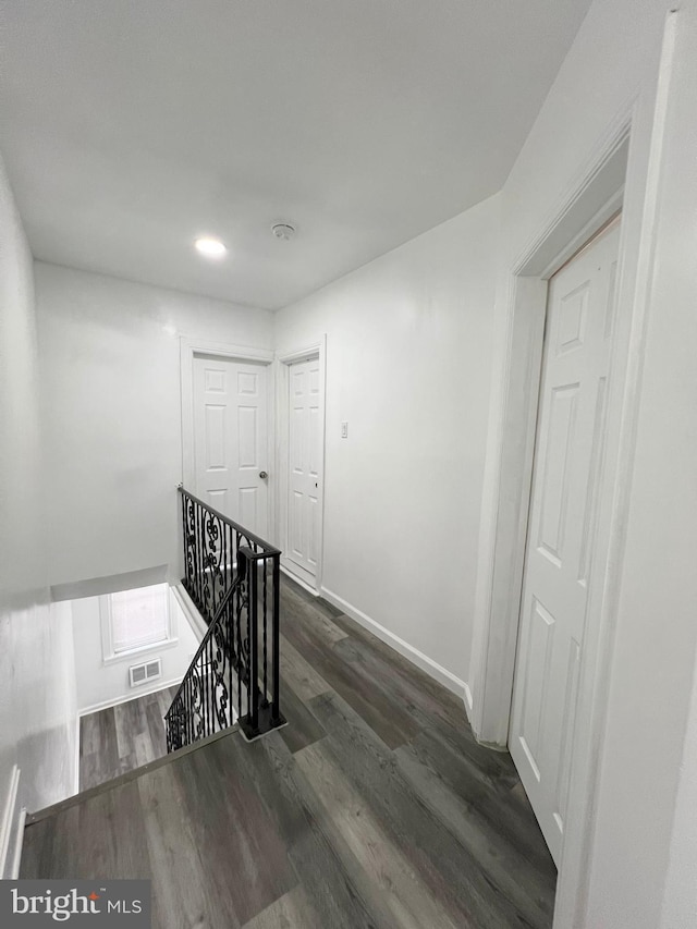 hallway with dark hardwood / wood-style floors