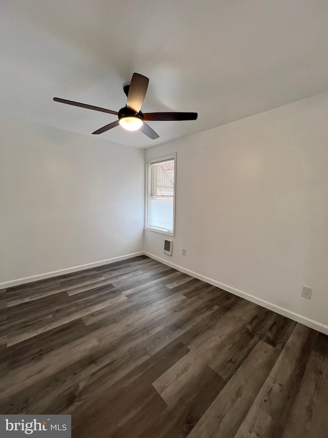 spare room featuring ceiling fan and dark hardwood / wood-style floors