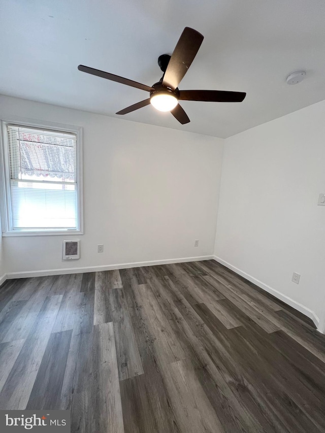 spare room with ceiling fan and dark hardwood / wood-style floors