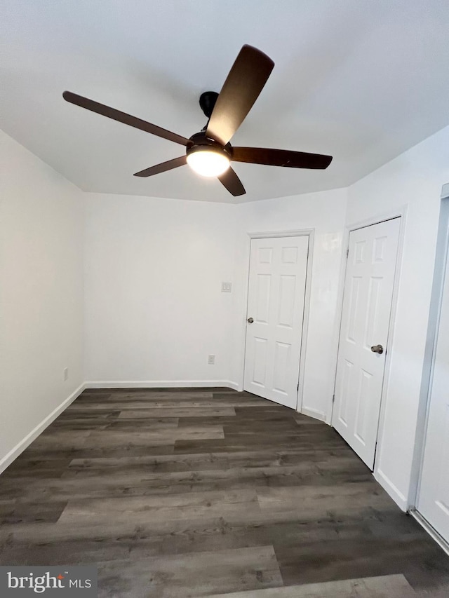 interior space with ceiling fan and dark wood-type flooring