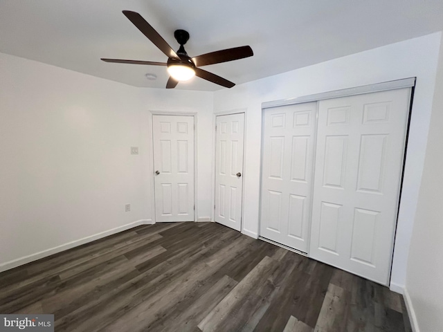 unfurnished bedroom with ceiling fan and dark hardwood / wood-style floors