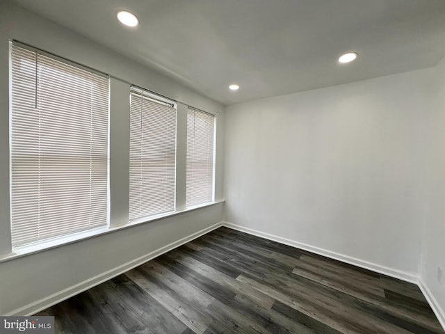 empty room with dark hardwood / wood-style floors